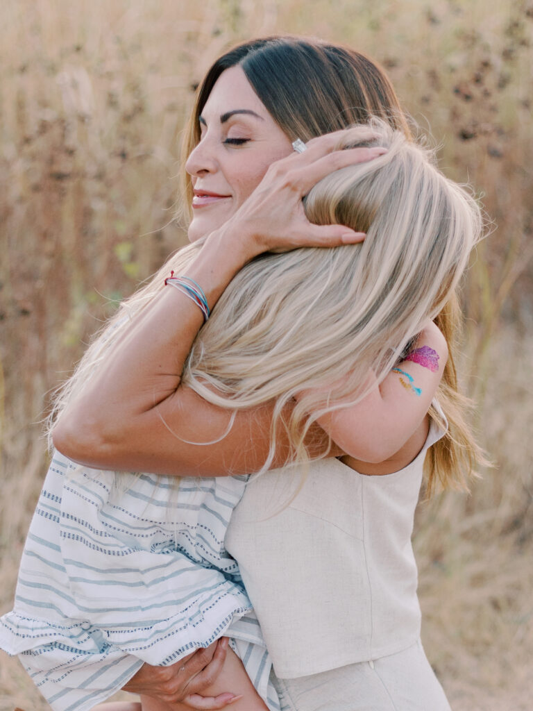 mom hugs girl