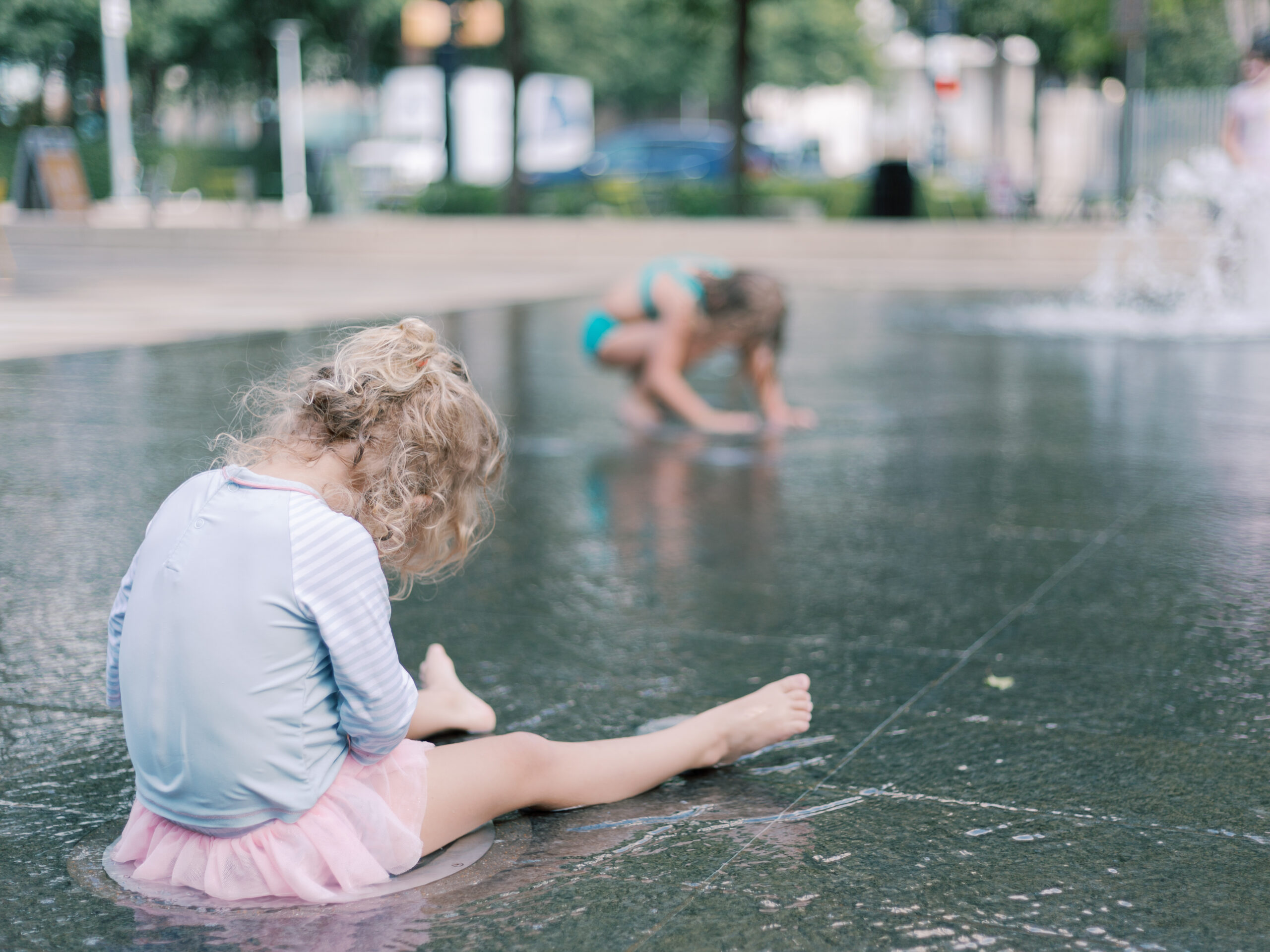 little girl playing in the fountain at Klyde Warren Park