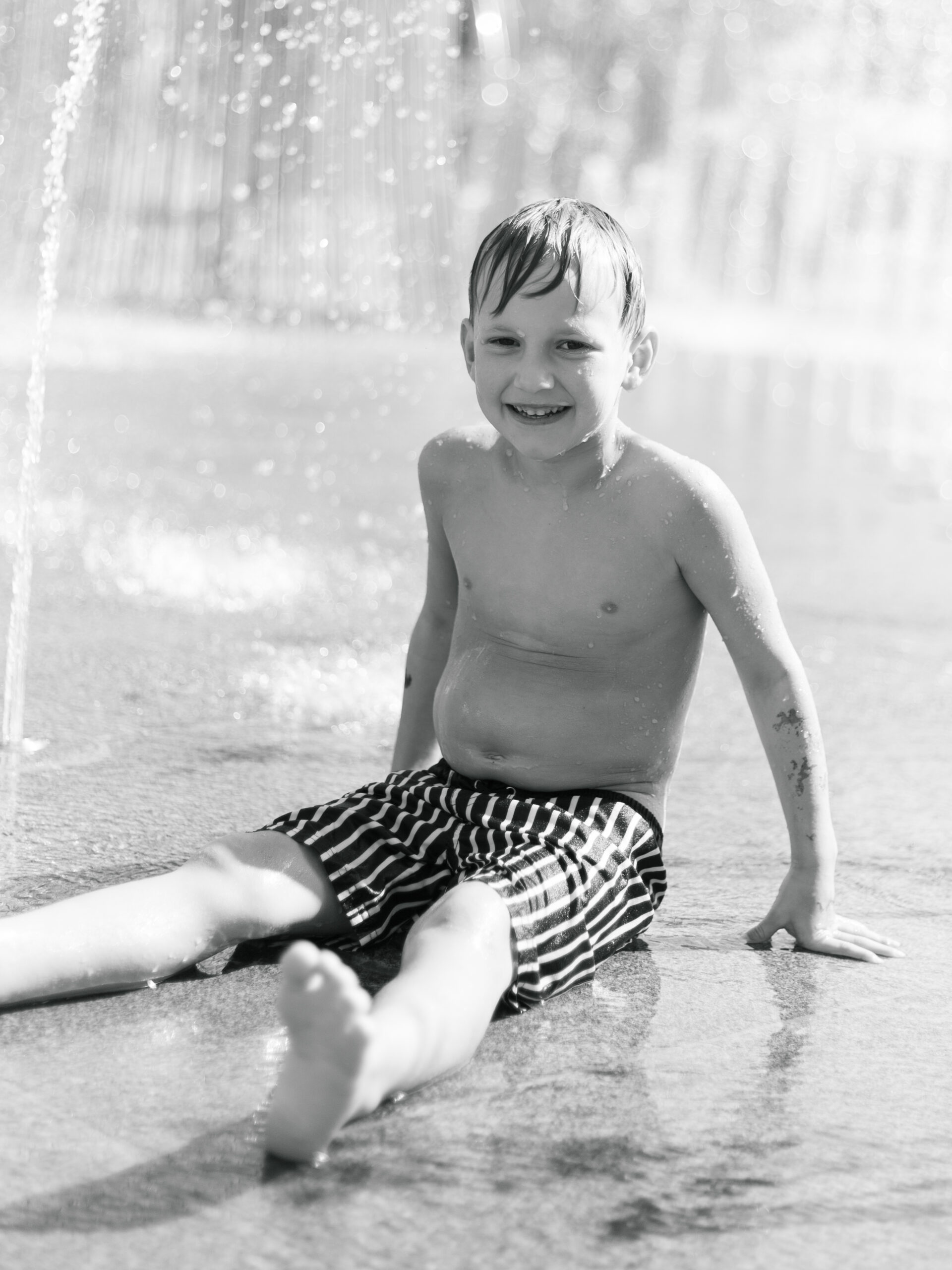 little boy playing in the fountain at Klyde Warren Park