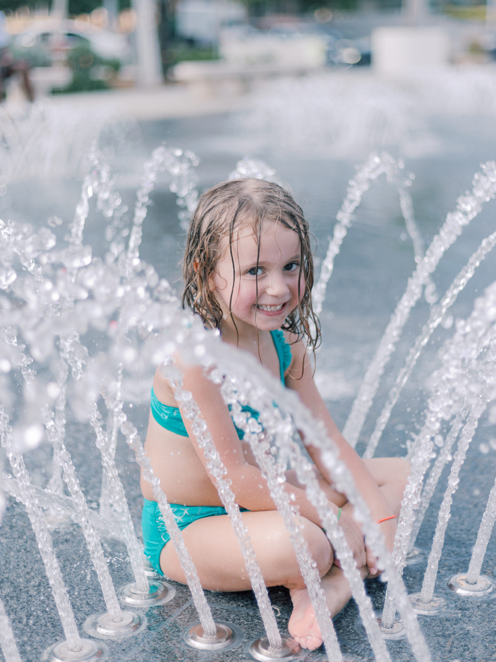 little girl playing in the fountain at Klyde Warren Park