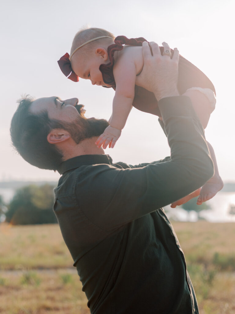 dad hods baby girl in the air at Winfrey Point, Dallas