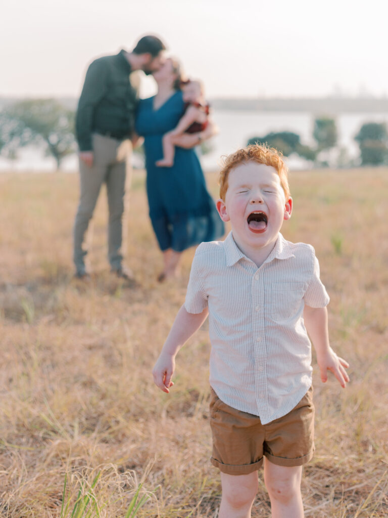 boy makes face parents kissing at Winfrey Point, Dallas