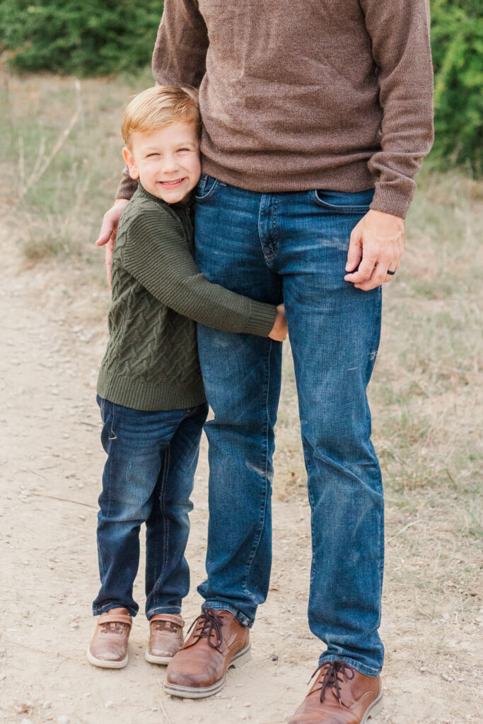 boy hugs dad's leg at Norbuck Park, Dallas TX, Kate White Photography
