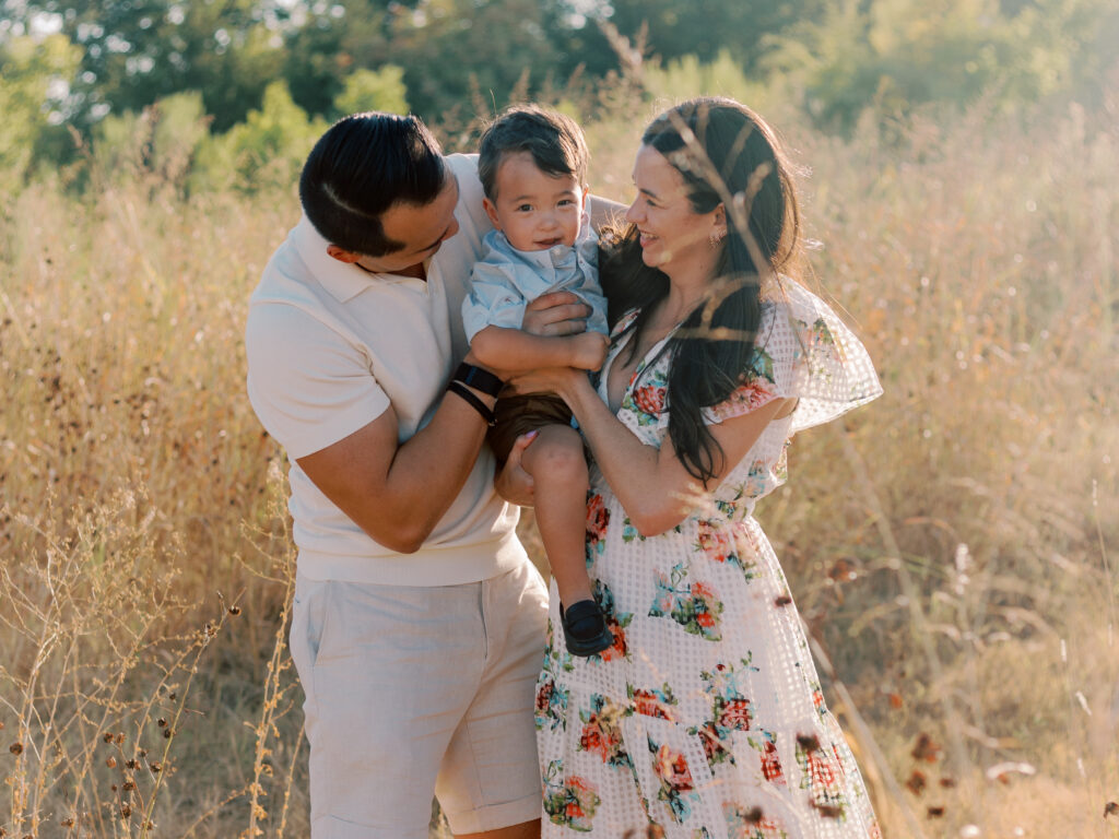 Family in a field at White Rock Lake Dallas TX by Kate White Photography