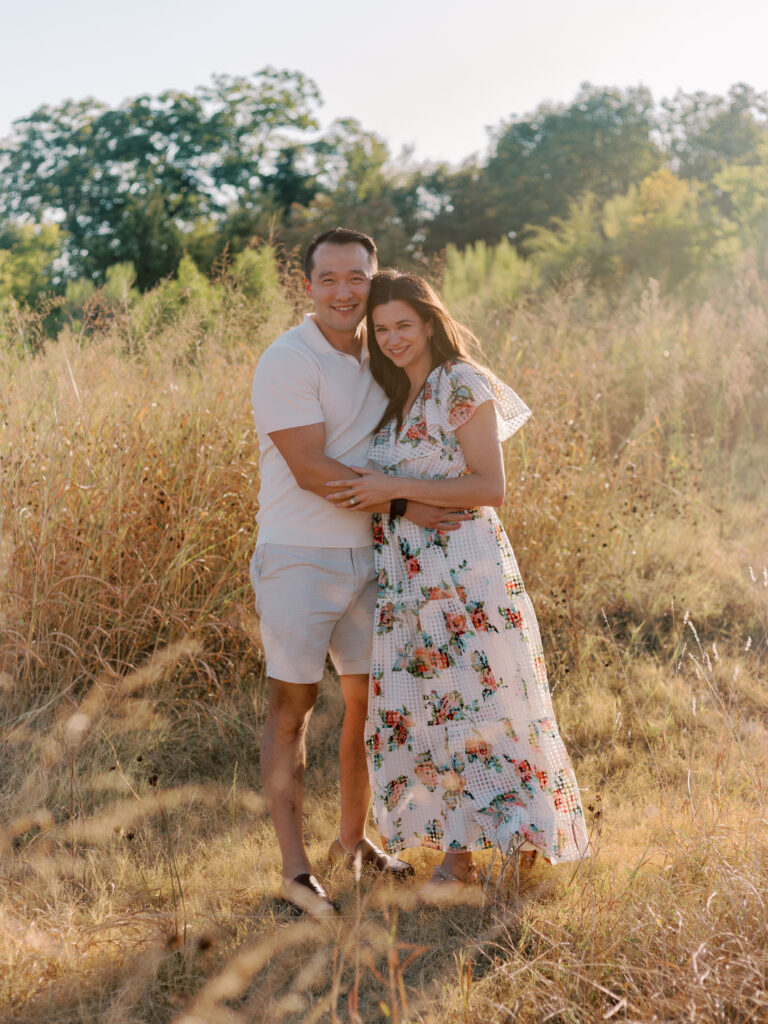 Couple in a field at White Rock Lake Dallas TX by Kate White Photography