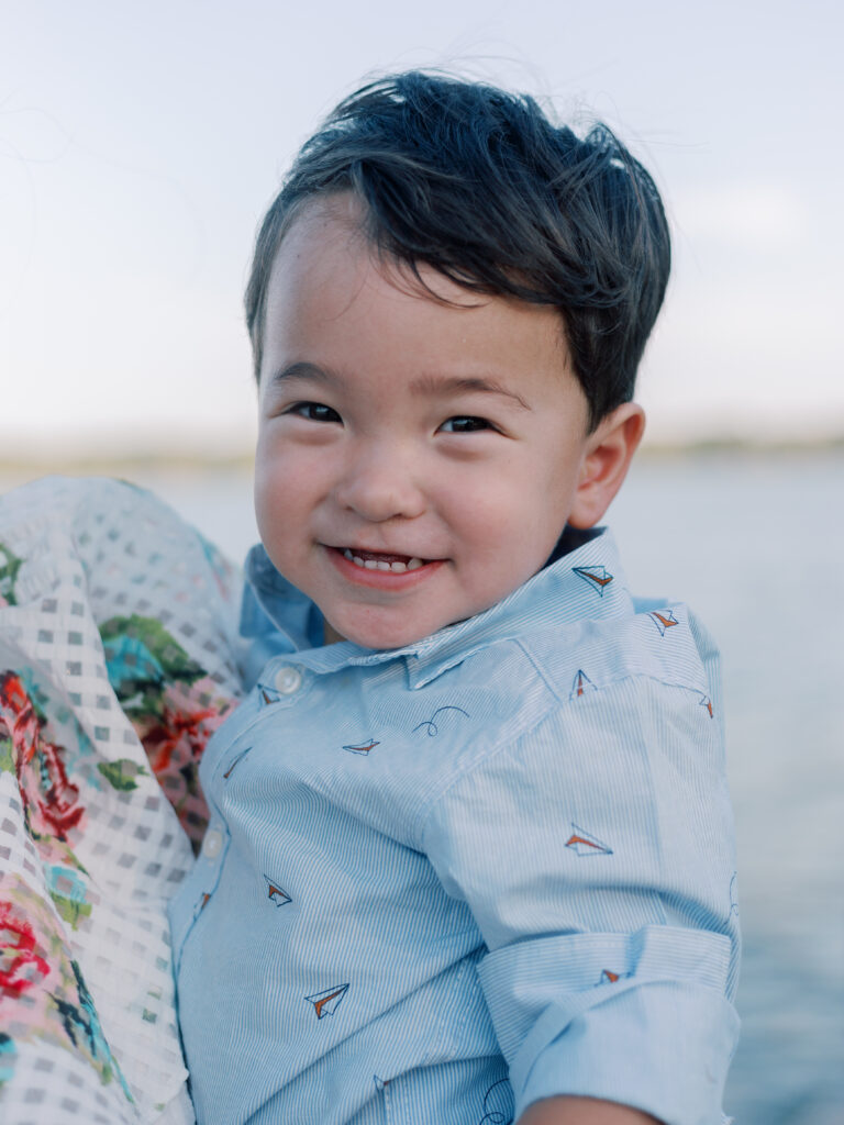 little boy smiles on the dock at White Rock Lake Dallas TX by Kate White Photography