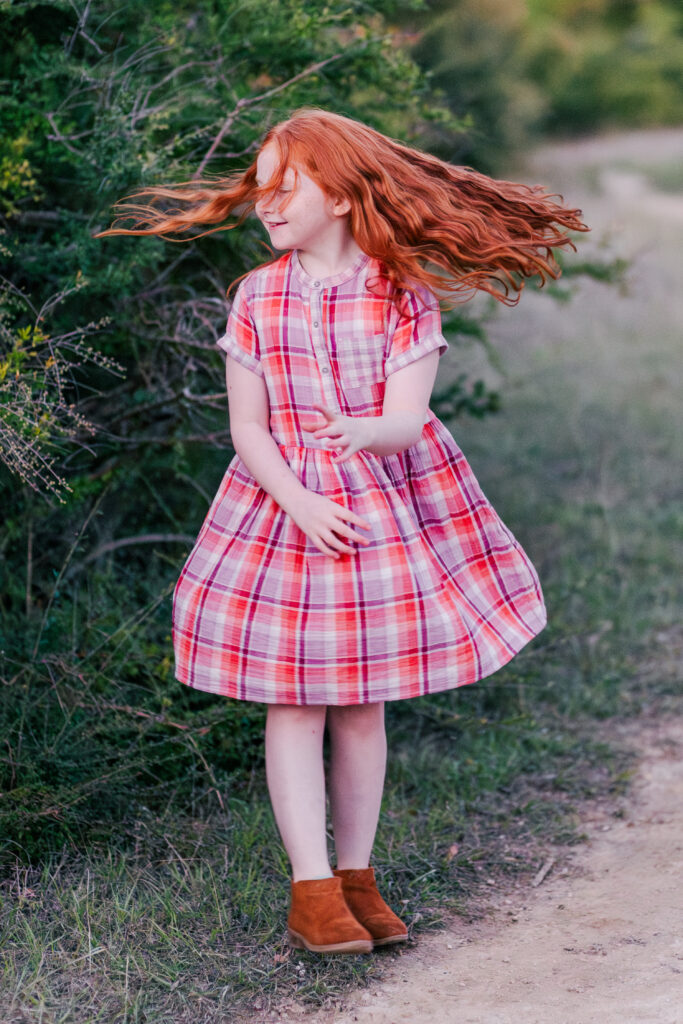 girl twirling at Norbuck Park in Dallas TX by Kate White Photography