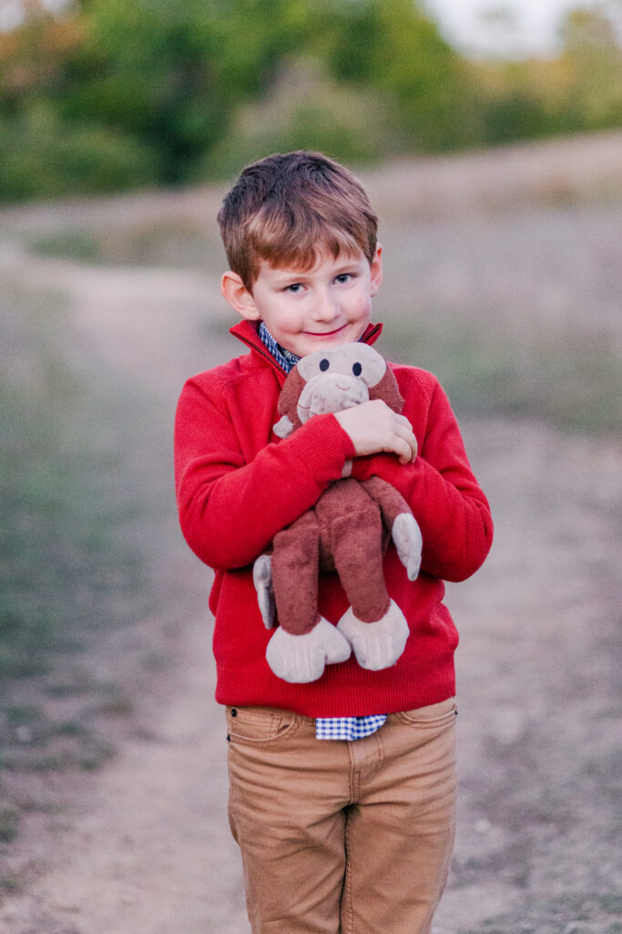 little boy and stuffed monkey at Norbuck Park in Dallas TX by Kate White Photography
