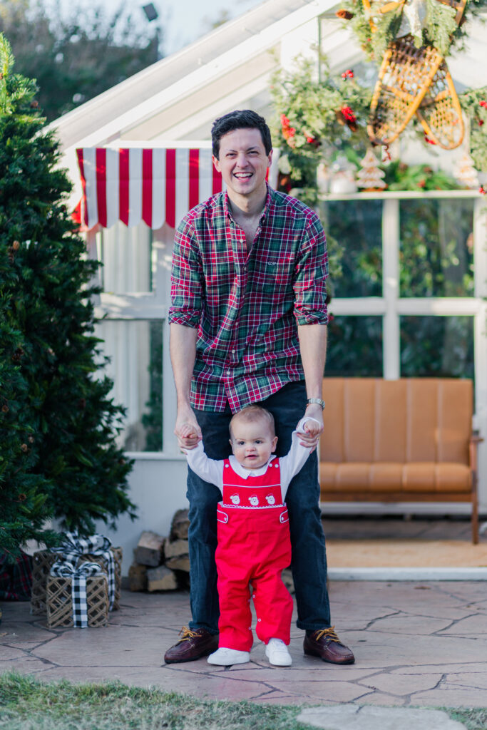 dad helps baby walk at the greenhouse at Lemon Drop Studios in McKinney with Kate White Photography