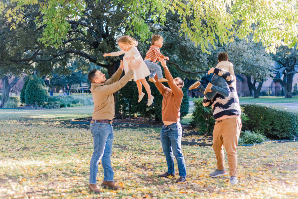 men throw children in the air by Kate White Photography 