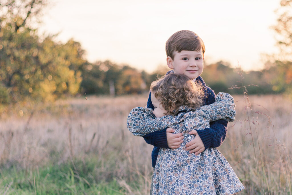 brother and sister hug at Norbuck Park by Kate White Photography