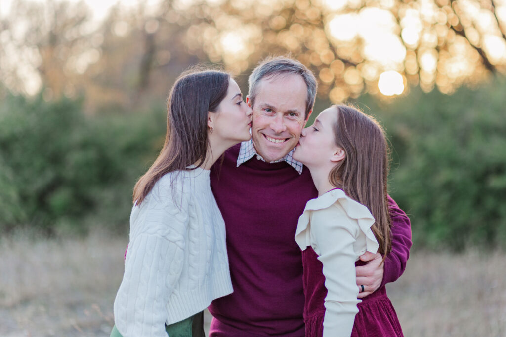 daughters kiss dad's cheeks at Norbuck Park by Kate White photography