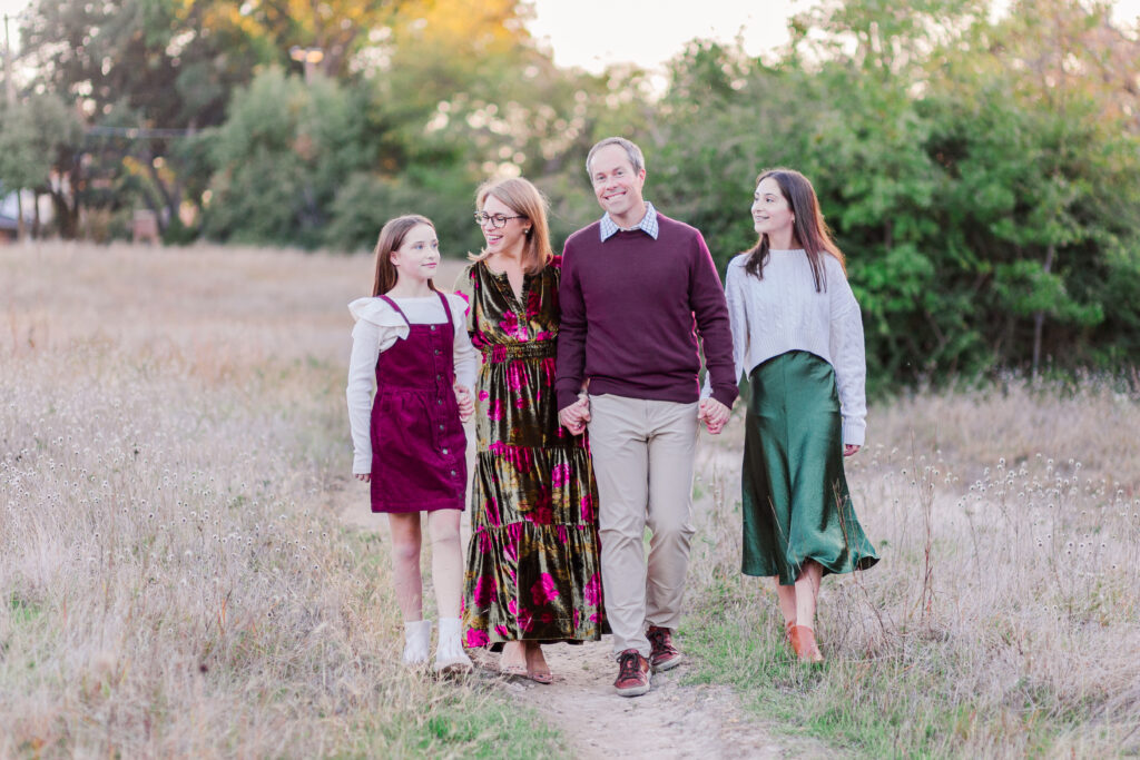 family walking through field at Norbuck Park by Kate White photography