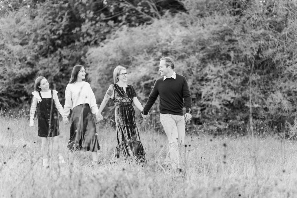 family walking through field at Norbuck Park by Kate White photography