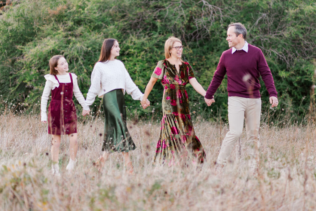 family walking through field at Norbuck Park by Kate White photography