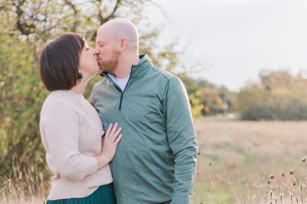 couple kisses at Norbuck Park by Kate White Photography