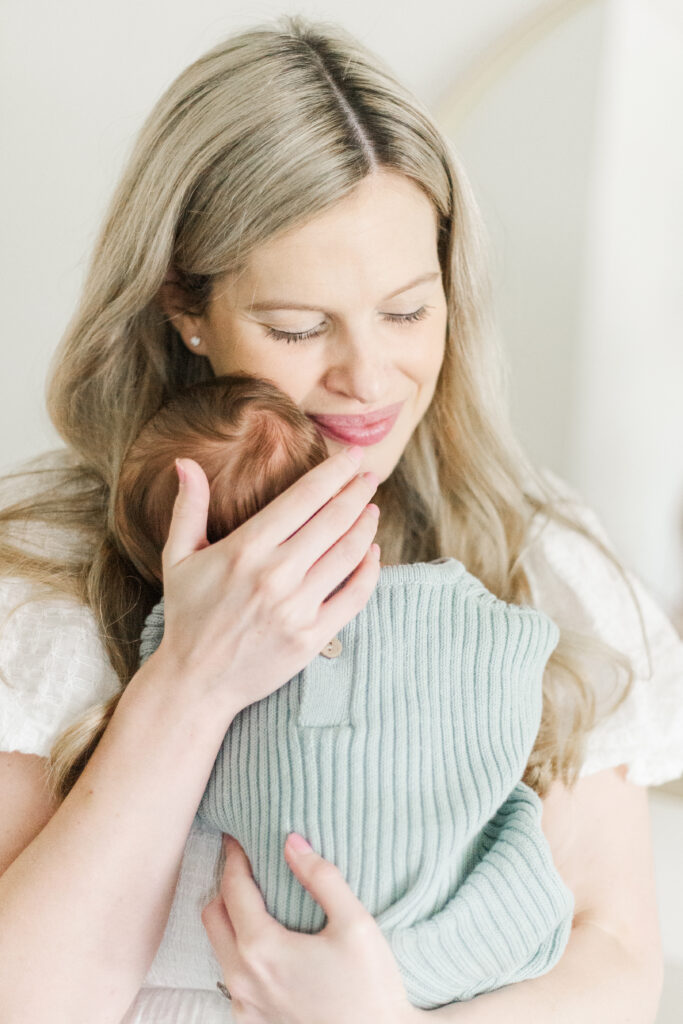 mom snuggles baby boy
