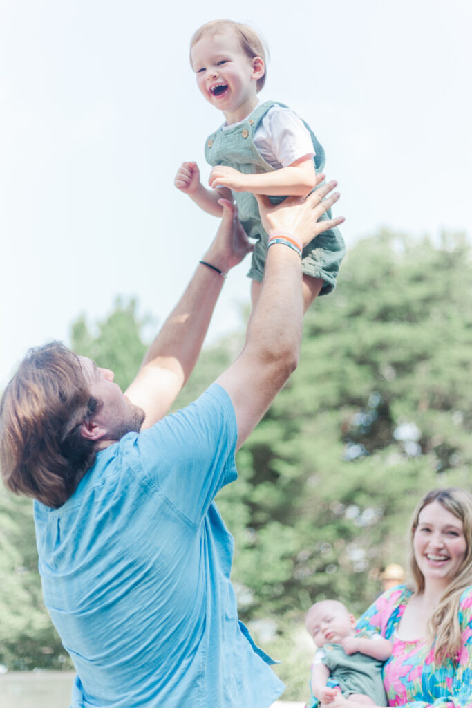 dad throws boy in the air