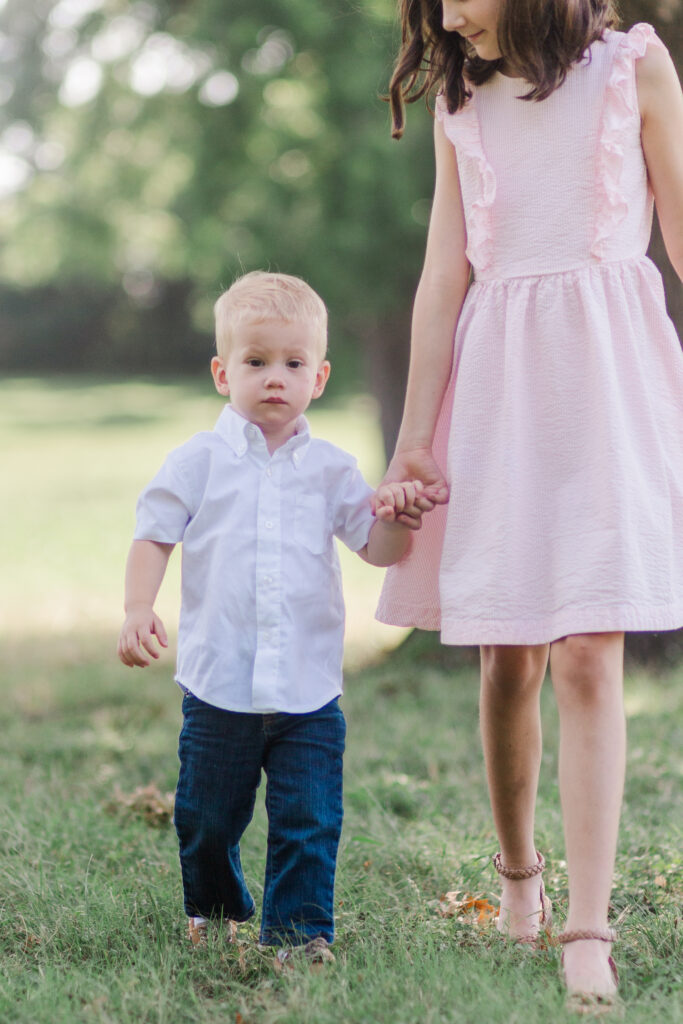 siblings walking at Harry S Moss Park in Dallas TX