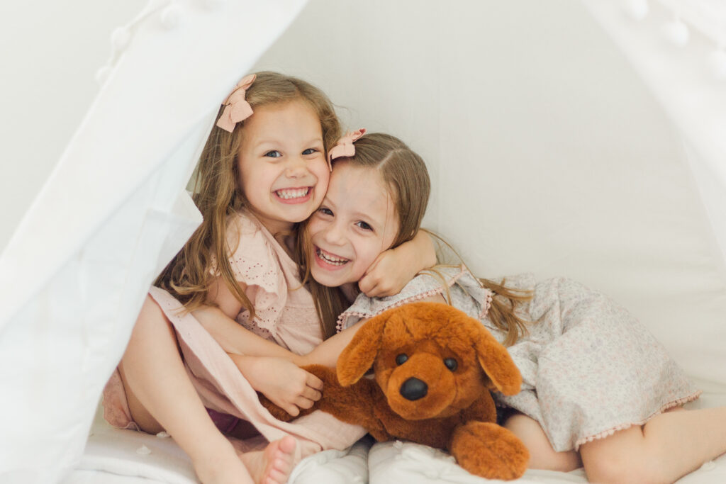 sisters hug in tent