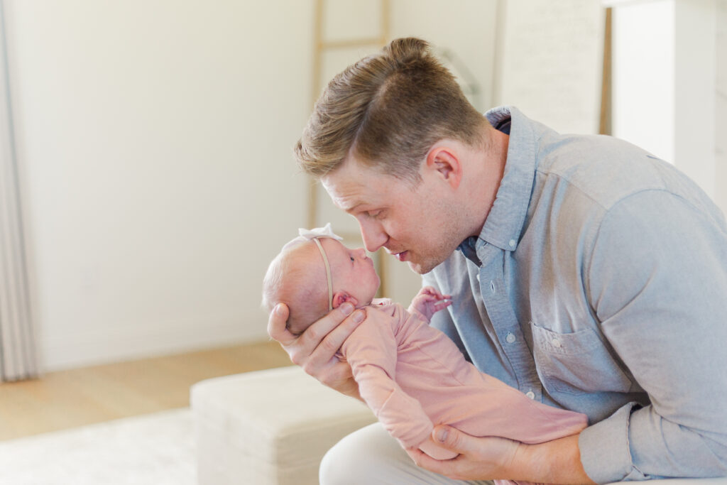 dad and baby girl touch noses