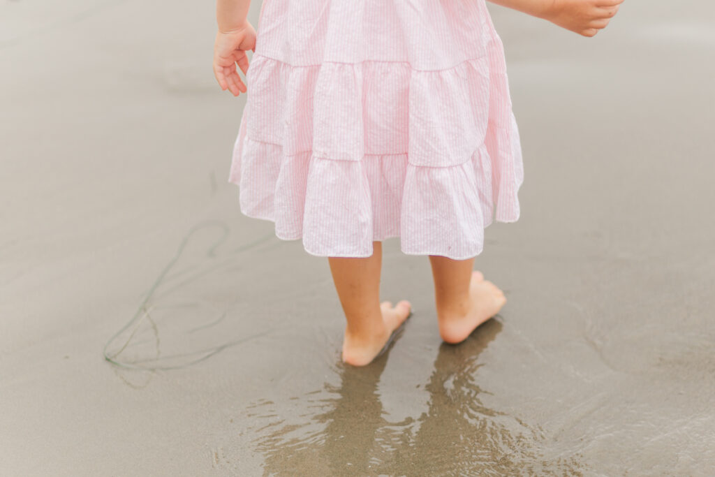 girl with toes in sand