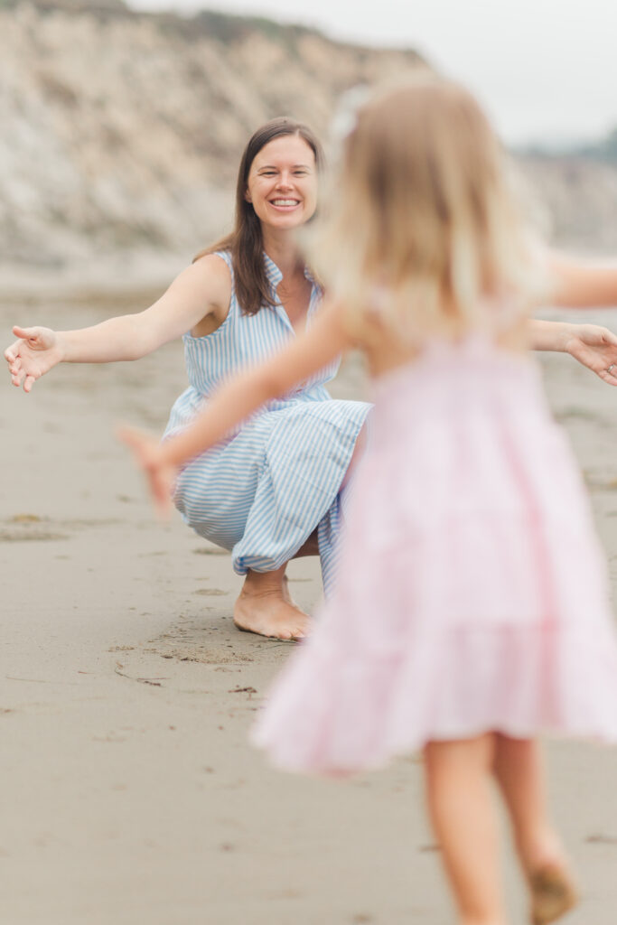 girl running to hug mom,