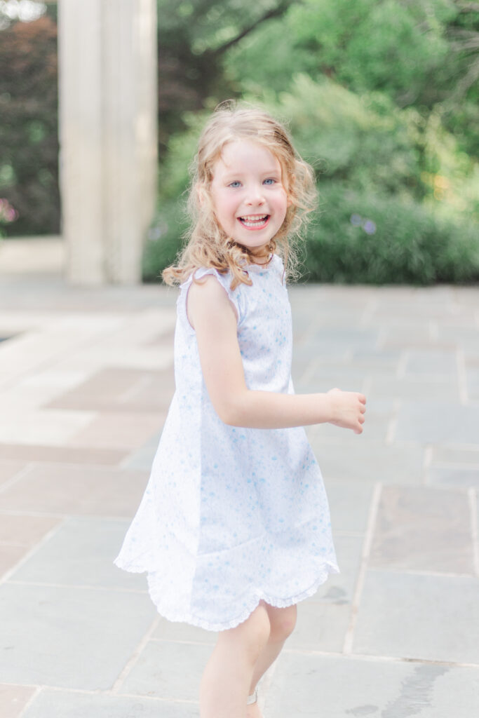 girl twirling at the Dallas Arboretum