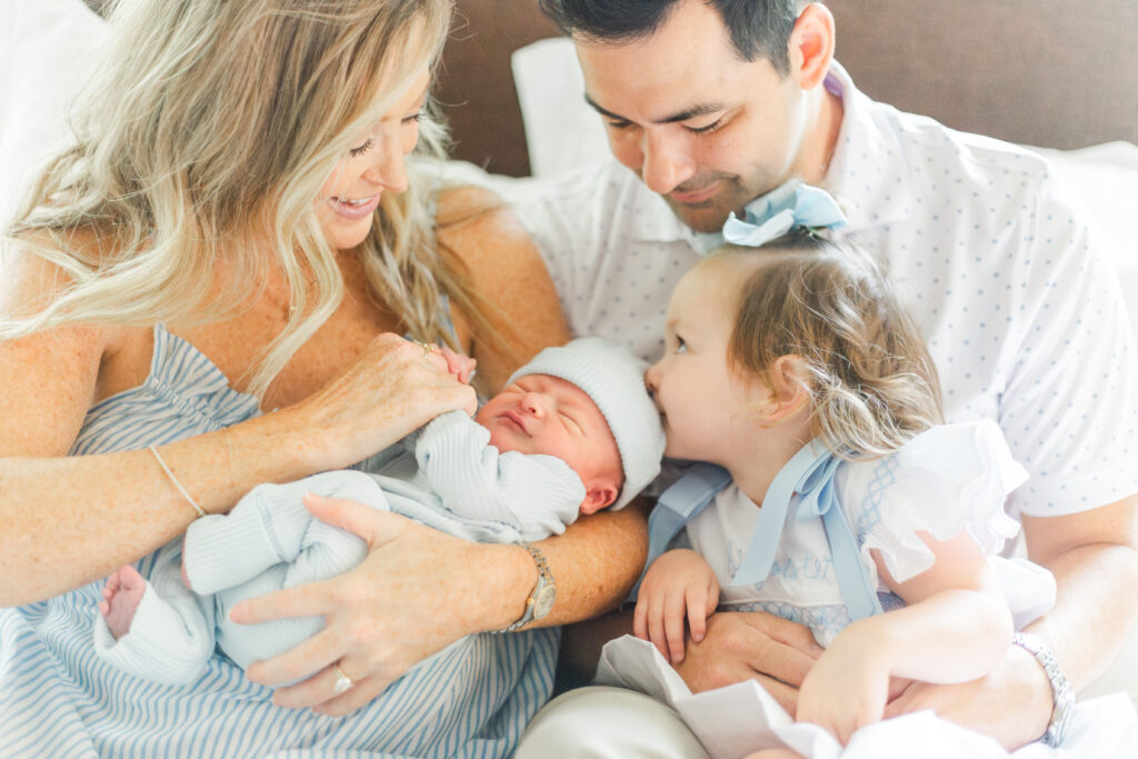 family snuggling new baby in Dallas TX