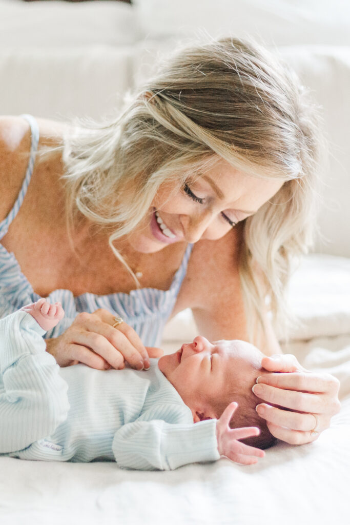 mom snuggling new baby in Dallas TX