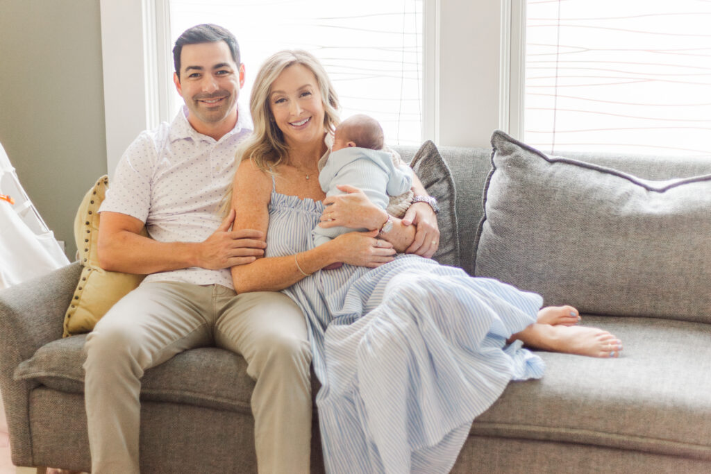 family snuggling new baby in Dallas TX