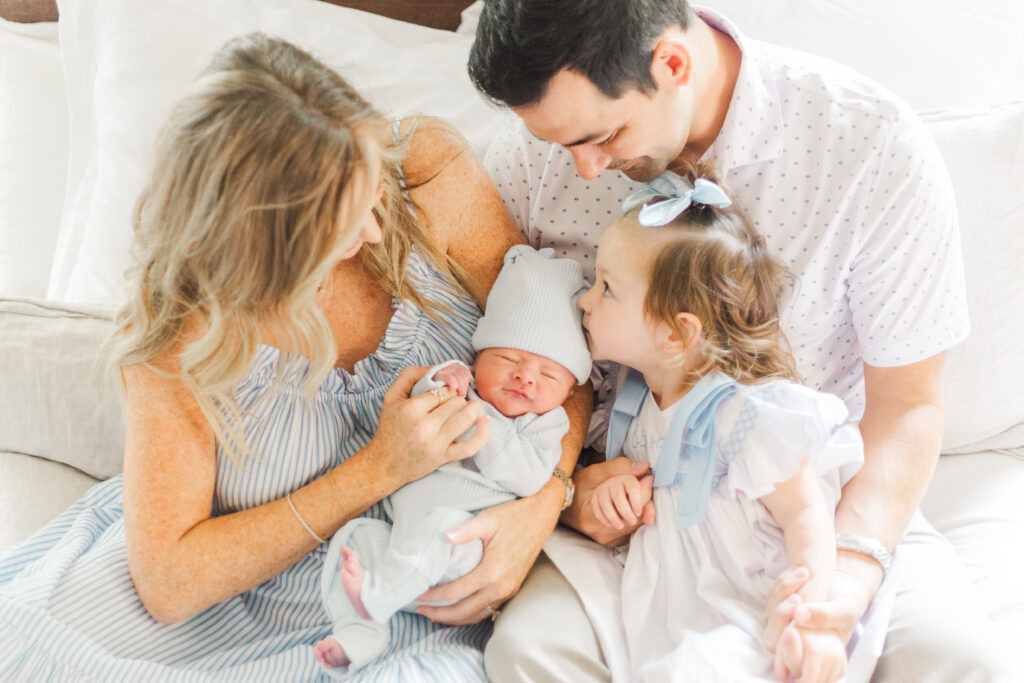 family snuggling new baby in Dallas TX