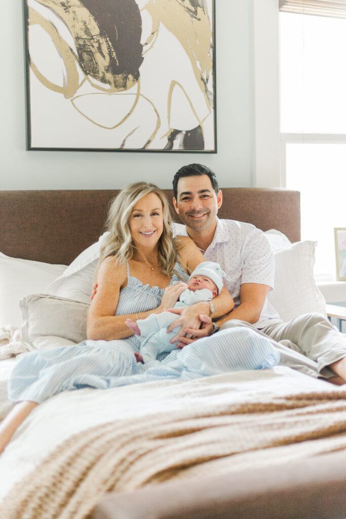 family snuggling new baby in Dallas TX