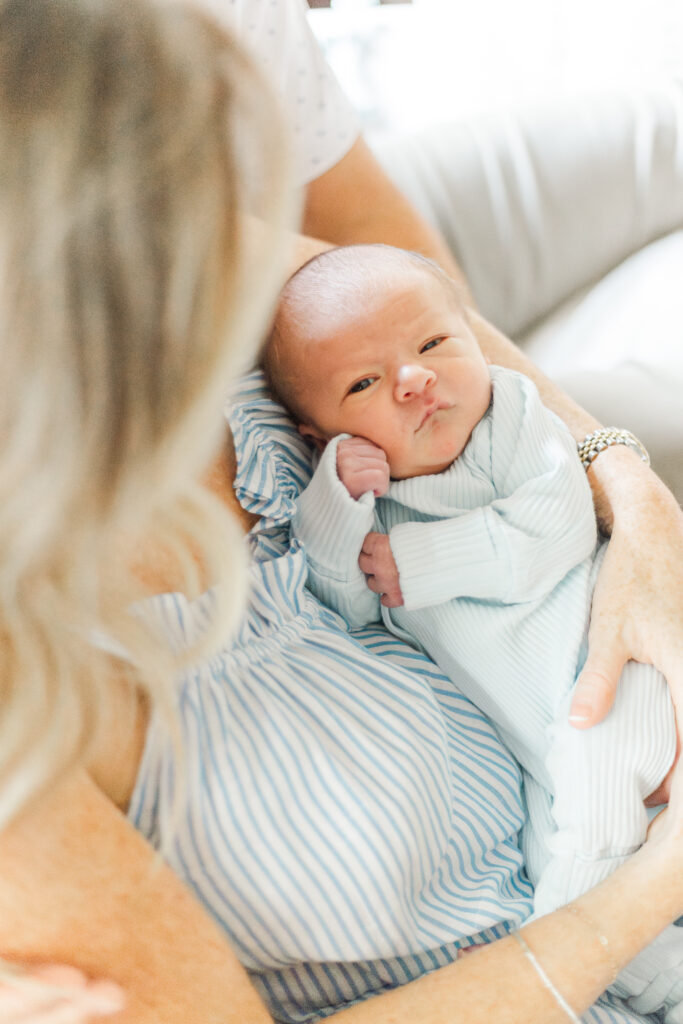 mom snuggling new baby in Dallas TX