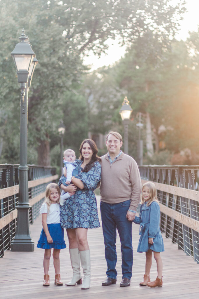 family stands on brdige