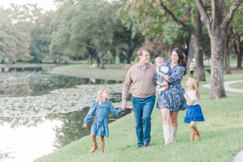 family walks along lakeside
