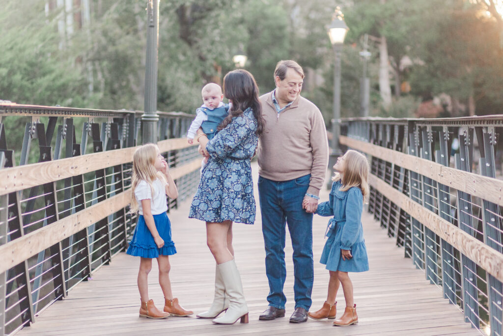 family laughs on bridge