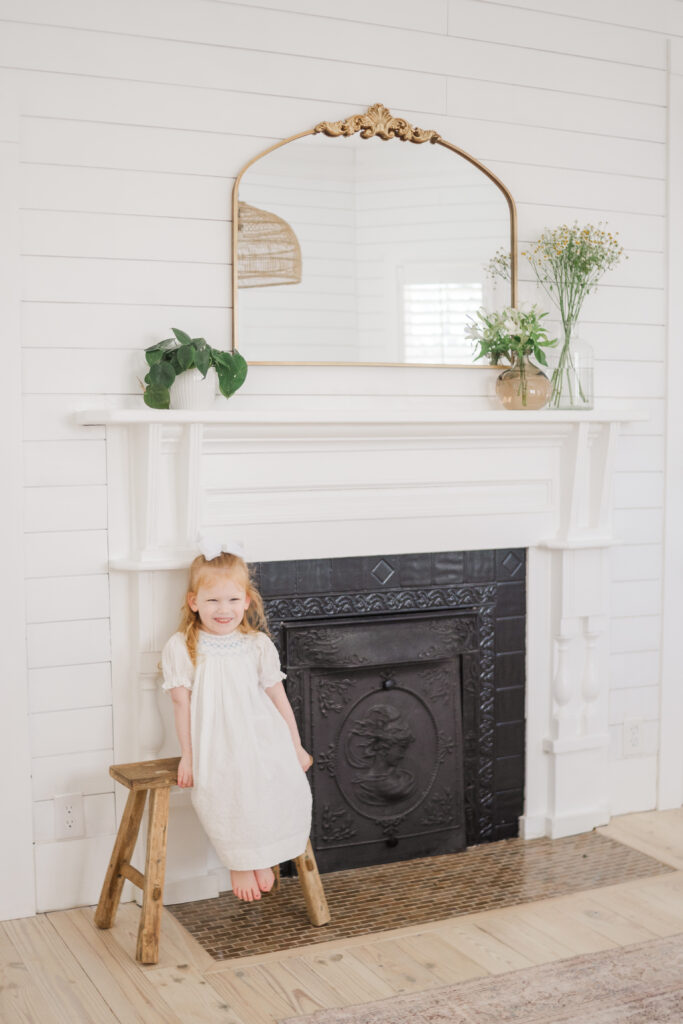girl by fireplace in McKinney at the Beverley Harris House