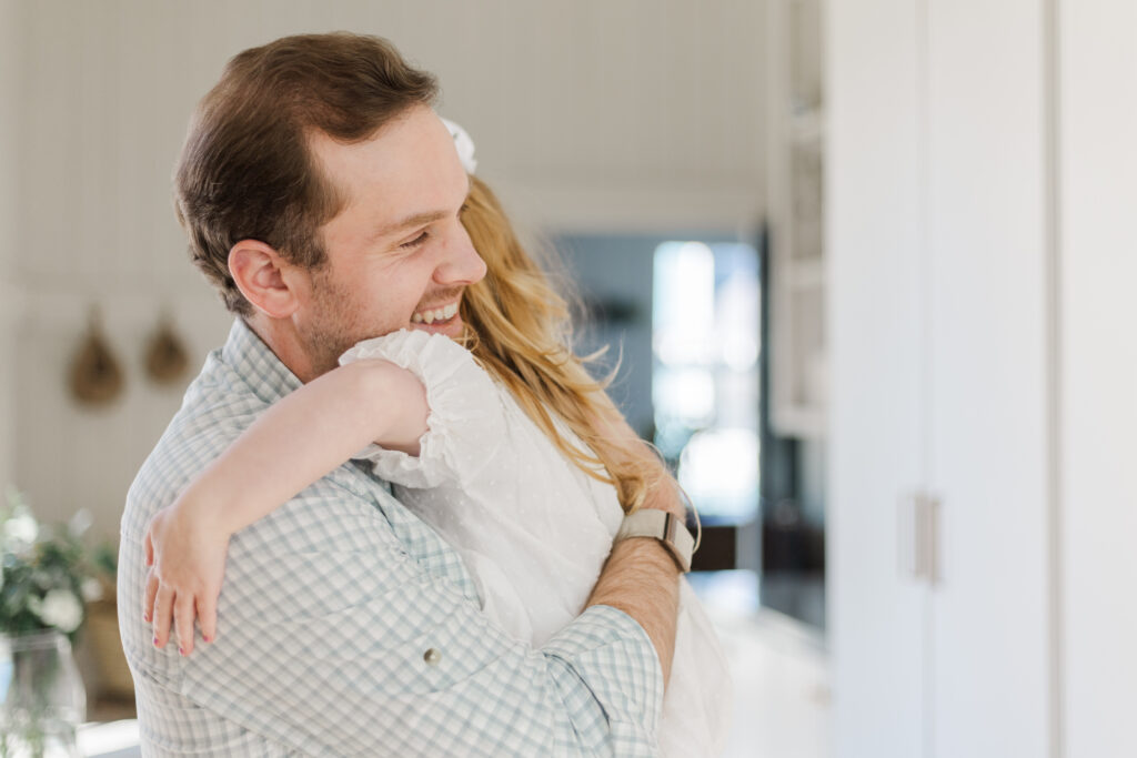dad hugging daughter in McKinney at the Beverley Harris House