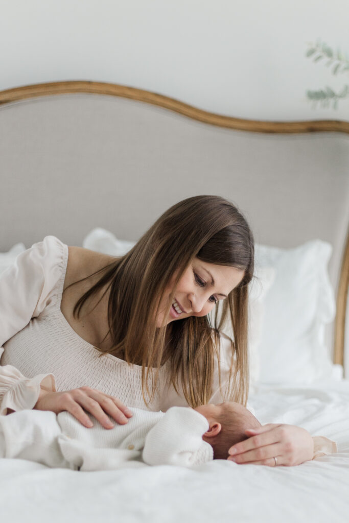 mom and newborn on bed at Lemon Drop Studios in McKinney TX