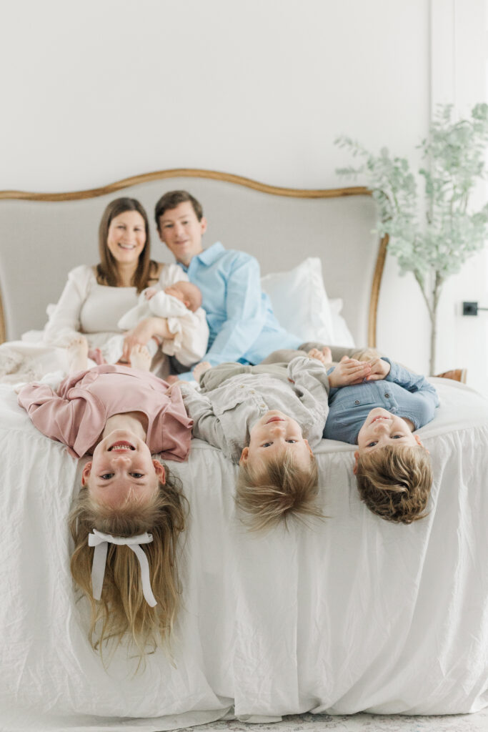 kids hang heads off end of bed at Lemon Drop Studios in McKinney TX