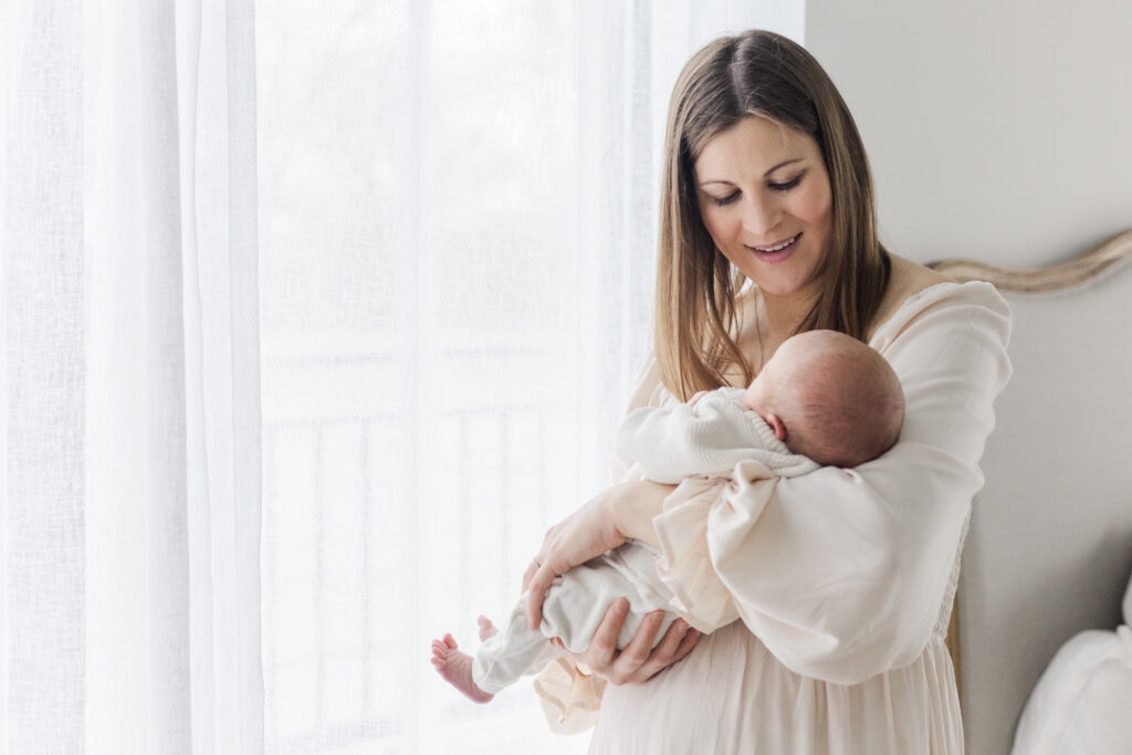 mom and baby by window at Lemon Drop Studios in McKinney TX