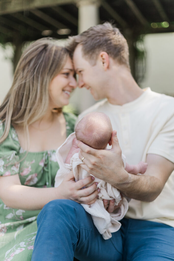 couple with newborn at the Dallas arboretum