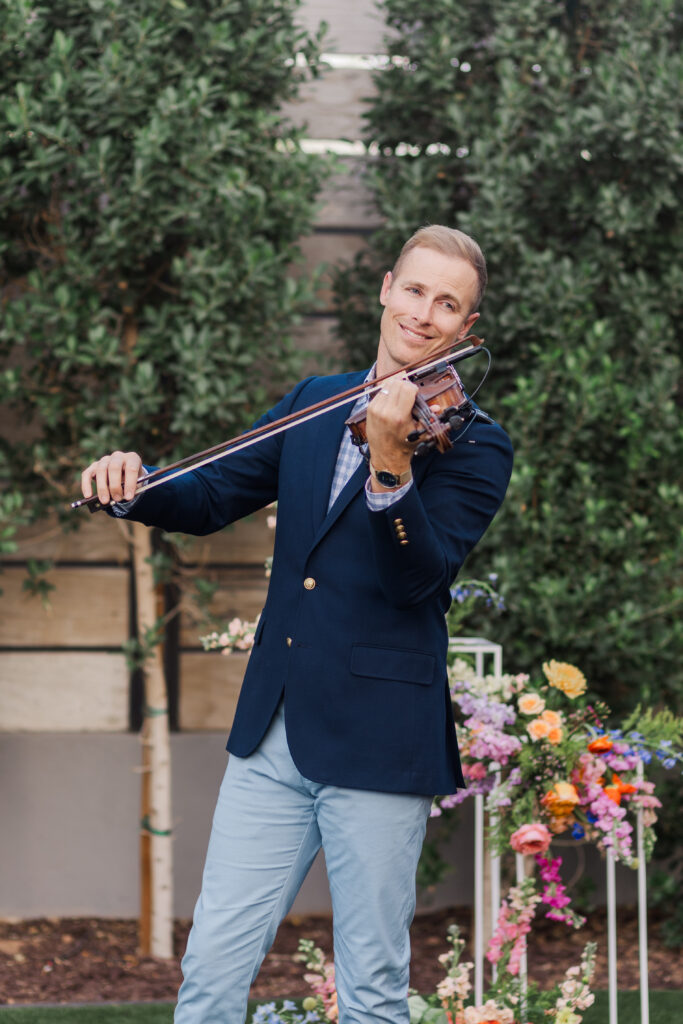 man lovingly playing gorgeous violin piece before wedding