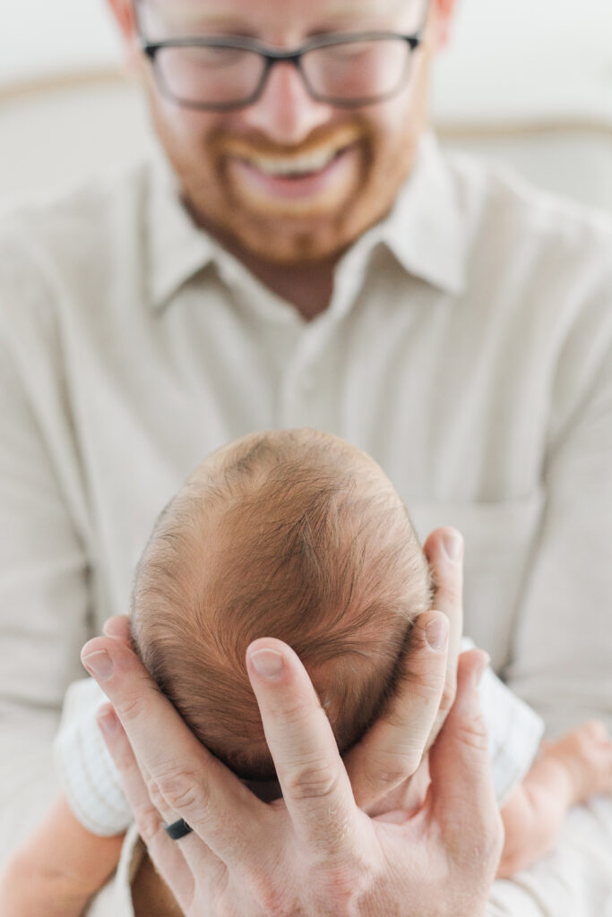 daddy smiling at his newborn boy