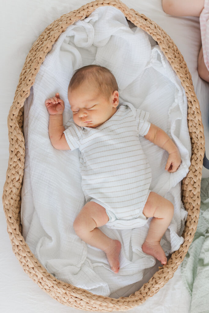 baby boy sleeps peacefully in a basket