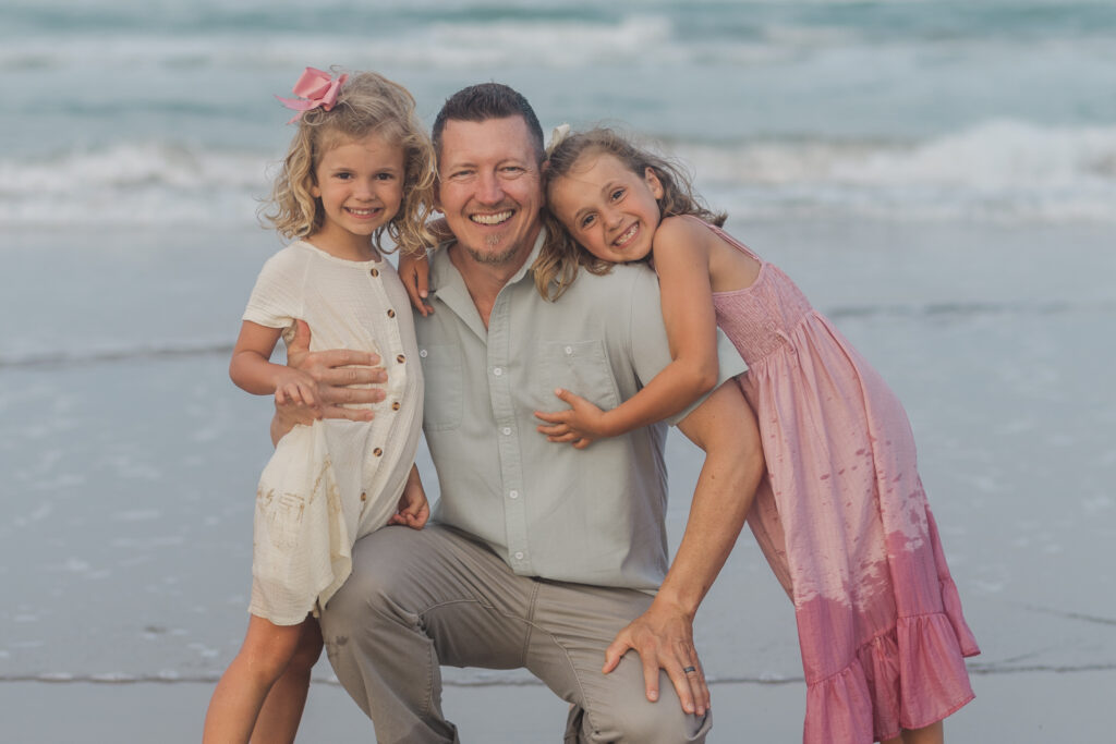 dad and daughters at the beach