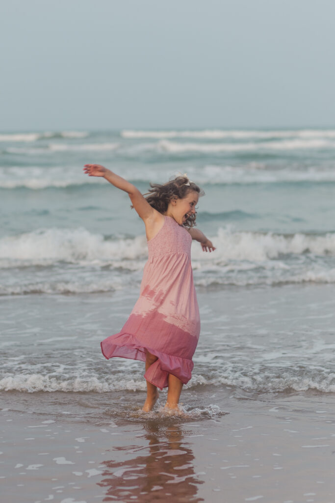 girl playing at the beach